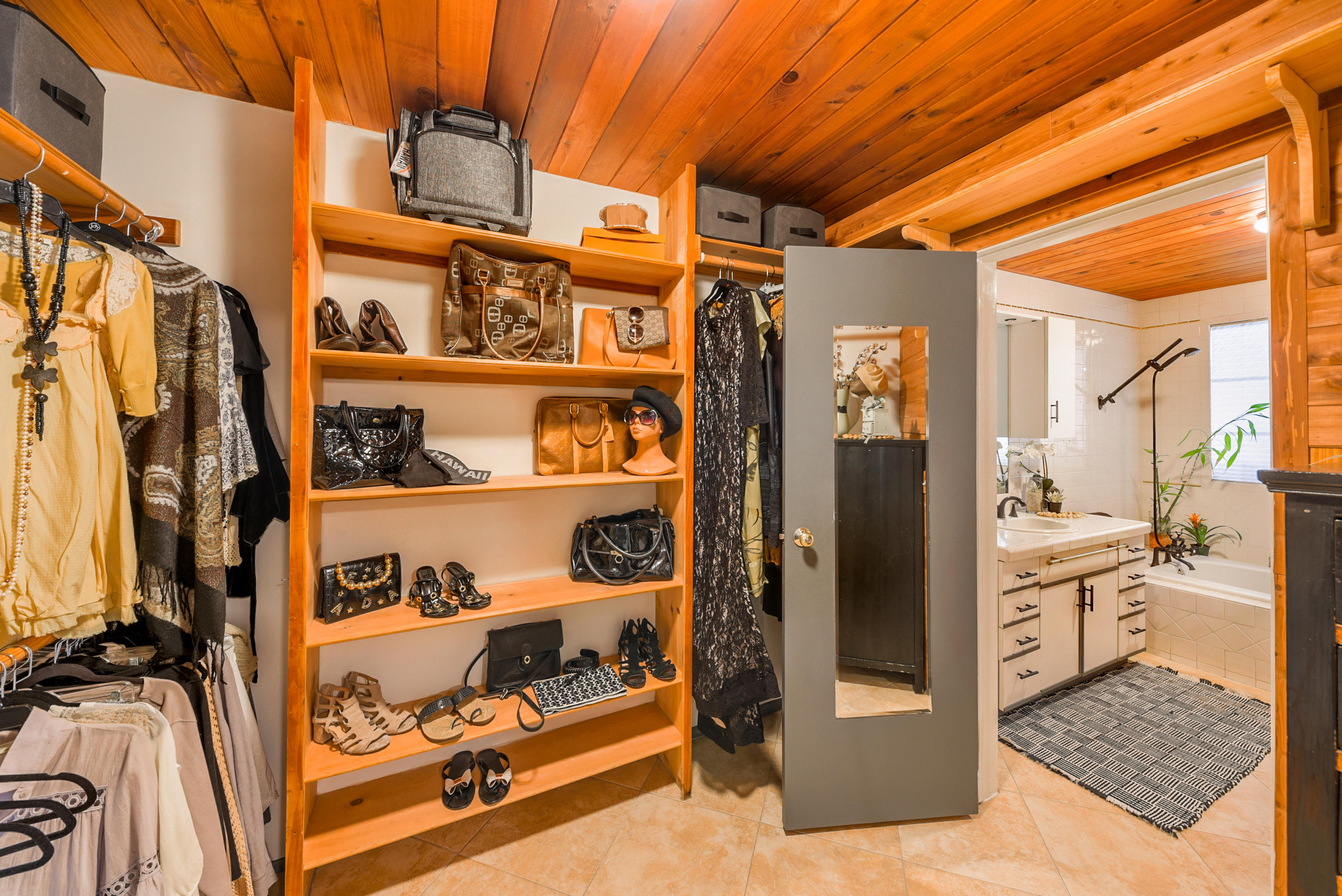 2306 Acacia Road East Palm Springs, CA 92262 - Photo 25 of 37 a view of walk in closet with clothes and shoes