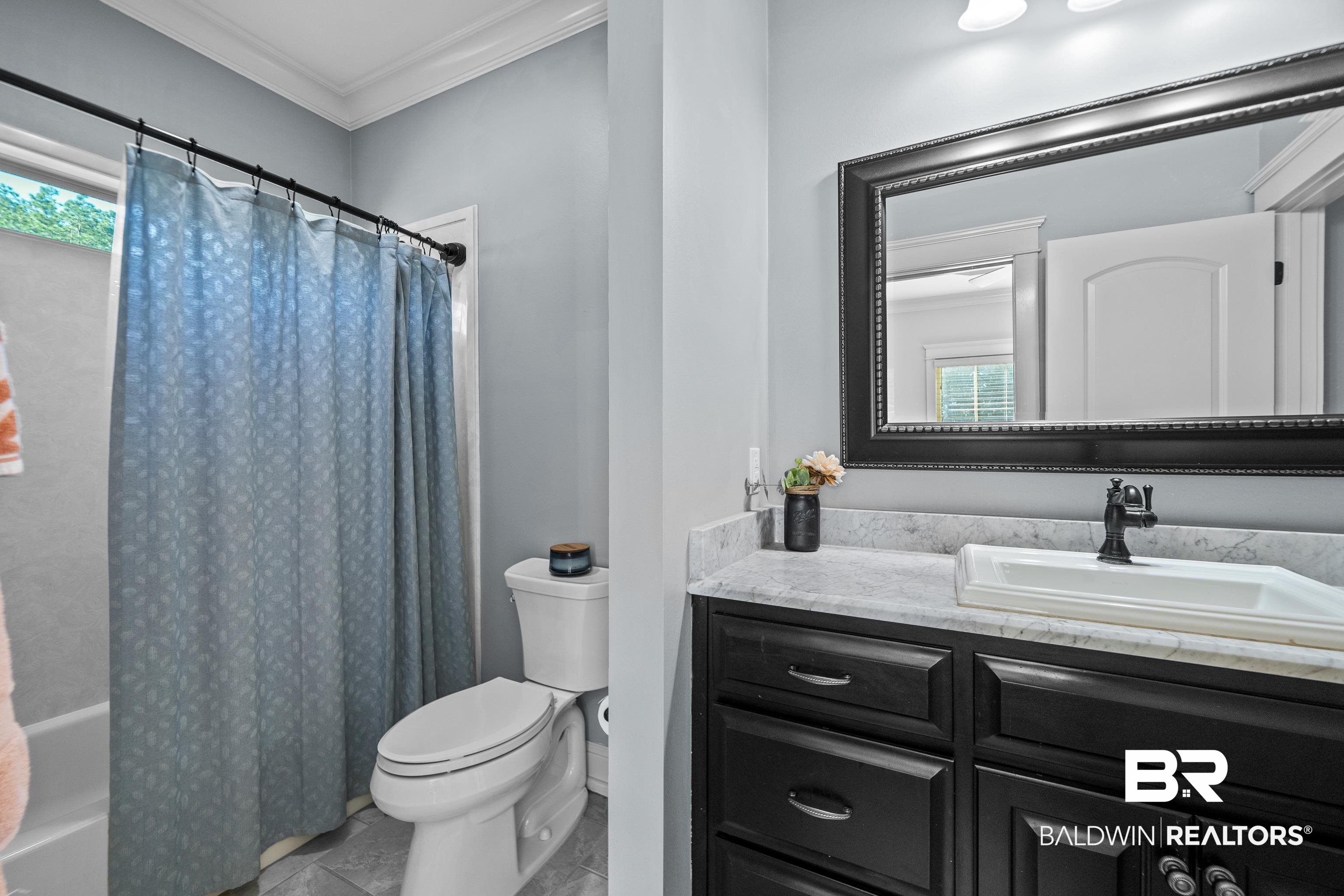 31829 Butler Drive Daphne, AL 36527 - Photo 34 of 48 Full bathroom with shower / bath combination with curtain, vanity, crown molding, and toilet