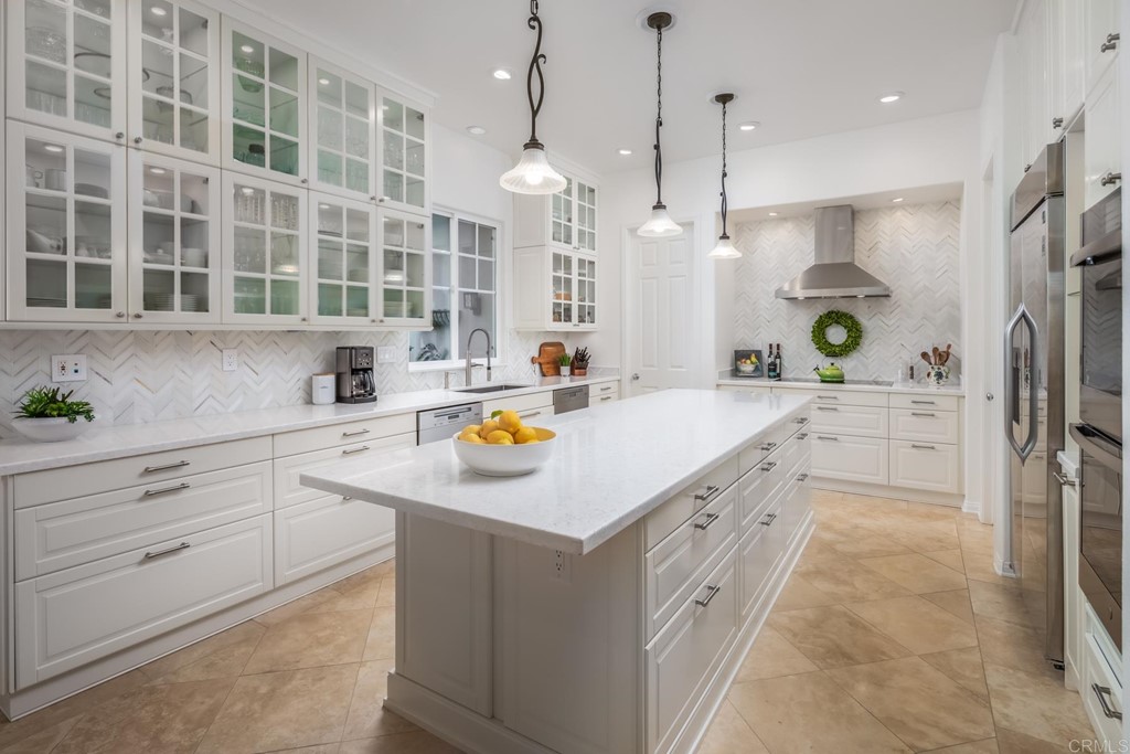 1464 Schoolhouse Way San Marcos, CA 92078 - Photo 16 of 48 a kitchen with stainless steel appliances granite countertop a sink and a refrigerator