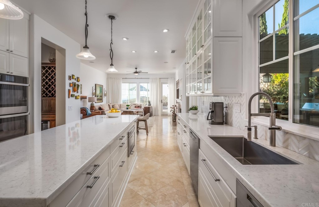 1464 Schoolhouse Way San Marcos, CA 92078 - Photo 18 of 48 a large kitchen with stainless steel appliances lots of counter space and a sink