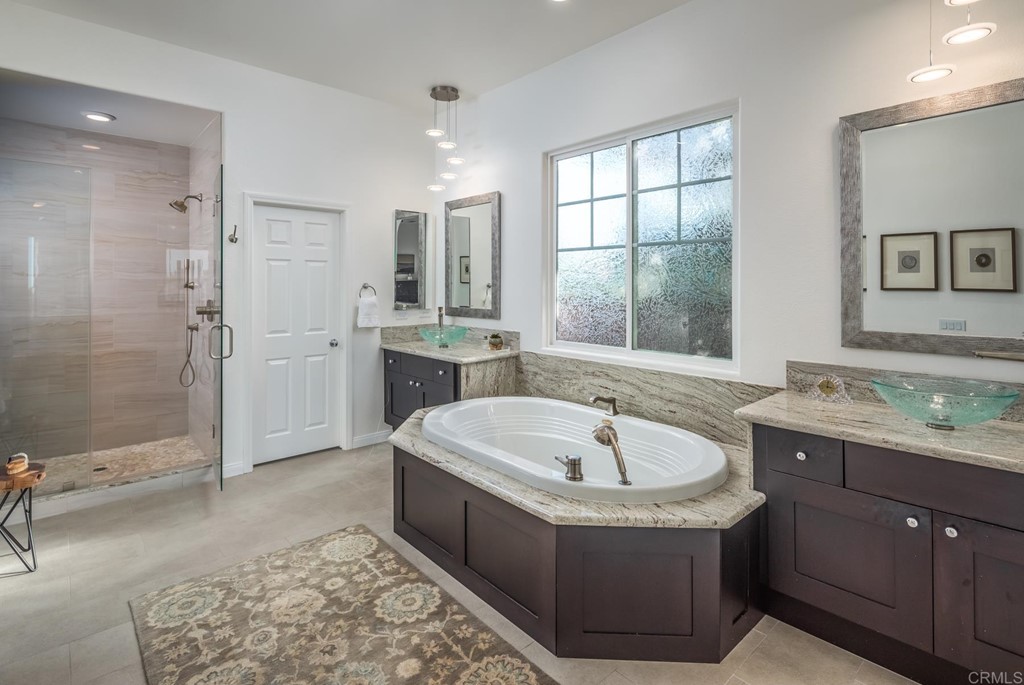 1464 Schoolhouse Way San Marcos, CA 92078 - Photo 22 of 48 a spacious bathroom with a tub sink shower and mirror