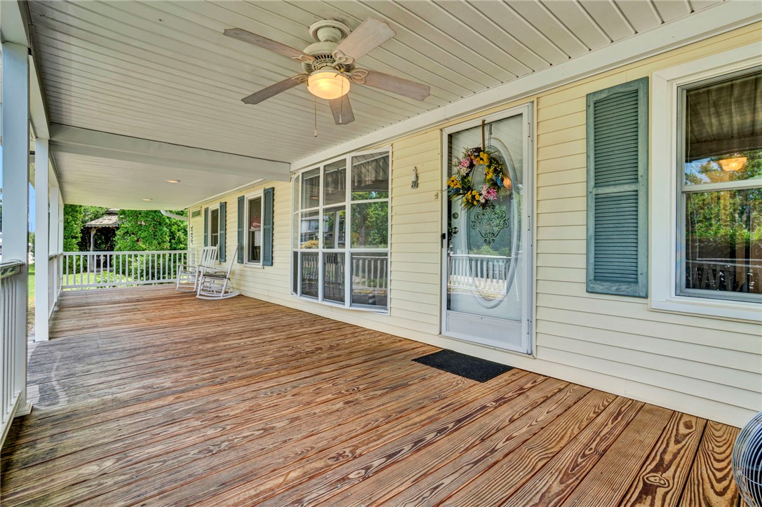 225 Nicholson Cove Road Seneca, SC 29672 - Photo 9 of 22 A deep wooden porch with a ceiling fan welcomes you to this charming residence.