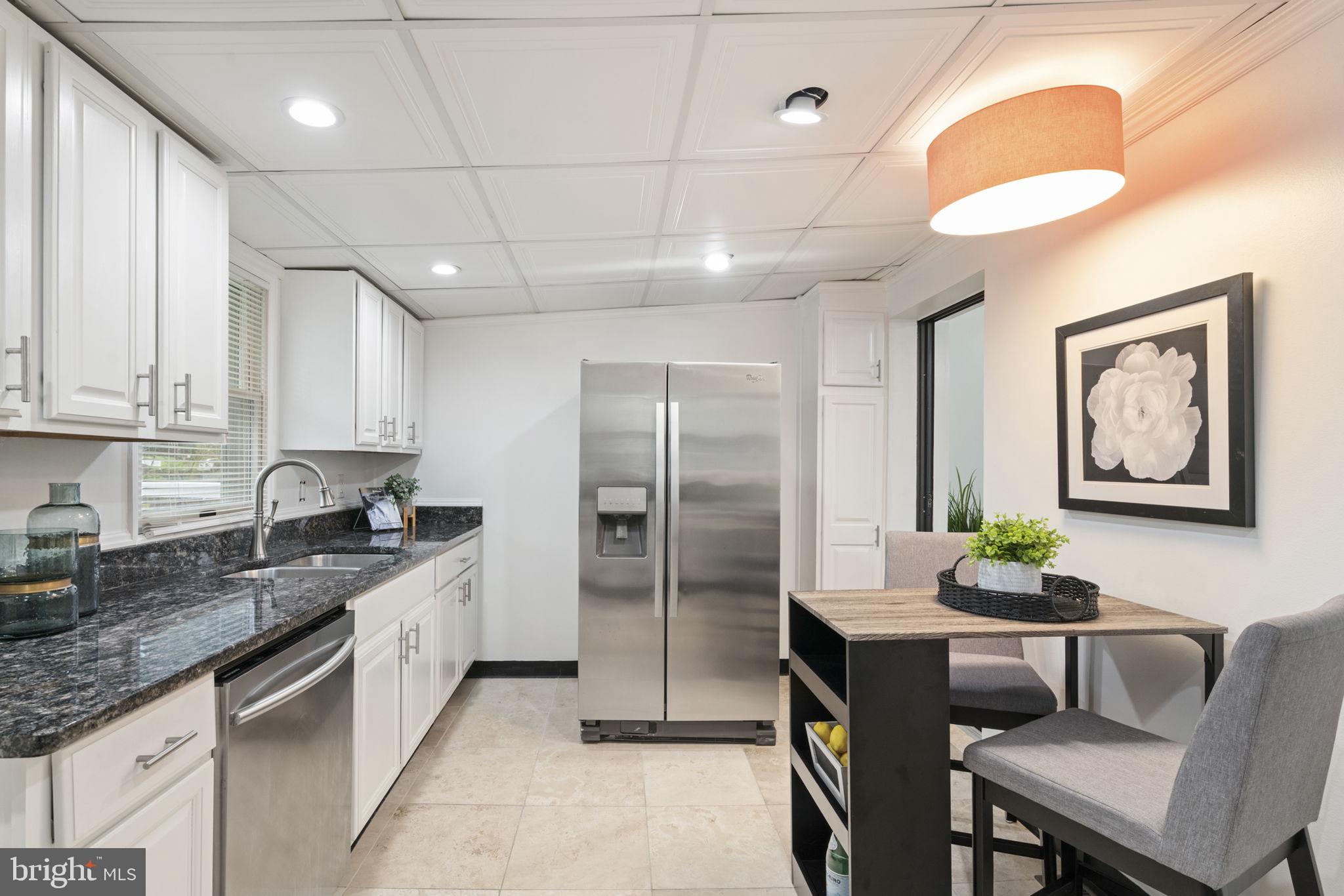 2732 Fort Drive Alexandria, VA 22303 - Photo 14 of 47 a kitchen with stainless steel appliances granite countertop a stove and a refrigerator