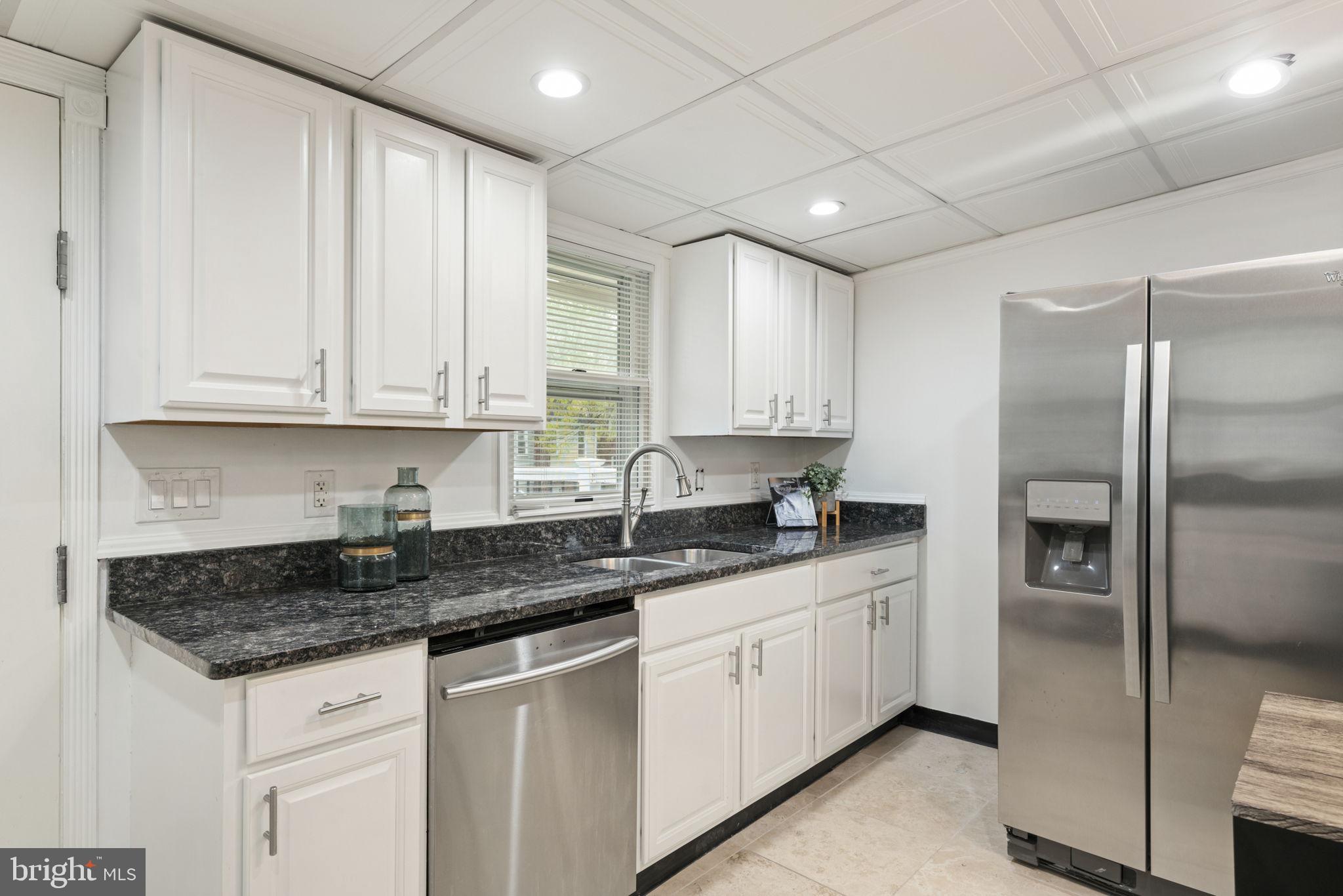2732 Fort Drive Alexandria, VA 22303 - Photo 15 of 47 a kitchen with stainless steel appliances granite countertop a sink stove and refrigerator