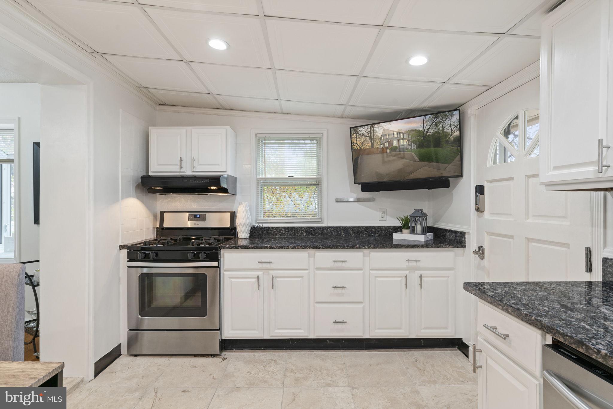 2732 Fort Drive Alexandria, VA 22303 - Photo 16 of 47 a kitchen with stainless steel appliances granite countertop a sink stove and microwave