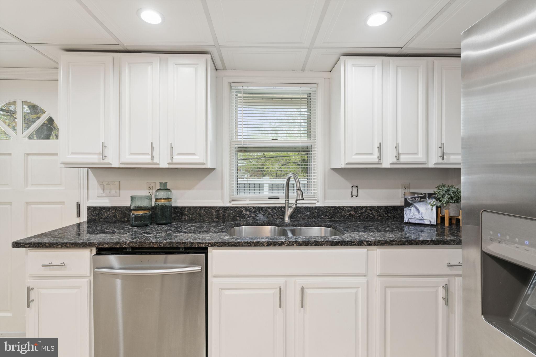 2732 Fort Drive Alexandria, VA 22303 - Photo 17 of 47 a kitchen with granite countertop white cabinets white appliances and a sink