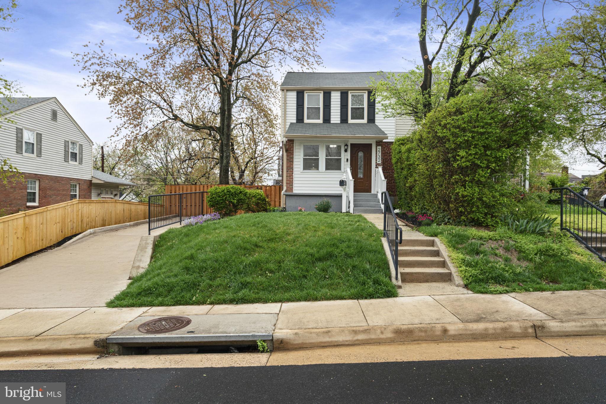 2732 Fort Drive Alexandria, VA 22303 - Photo 2 of 47 a front view of a house with a yard and garage