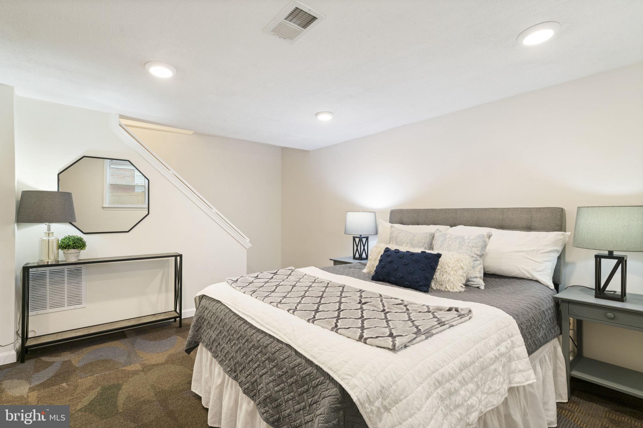 2732 Fort Drive Alexandria, VA 22303 - Photo 28 of 47 a bedroom with a large bed and a wooden floor