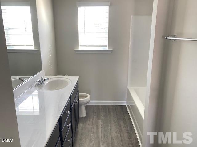 132 Montasel Court Fuquay-Varina, NC 27526 - Photo 17 of 20 a bathroom with a sink toilet and window