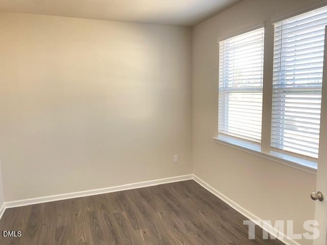 132 Montasel Court Fuquay-Varina, NC 27526 - Photo 2 of 20 an empty room with wooden floor and windows