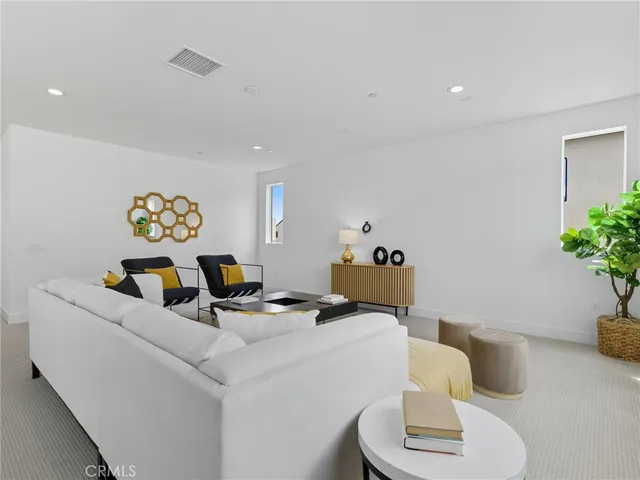 a dining room with furniture and potted plant