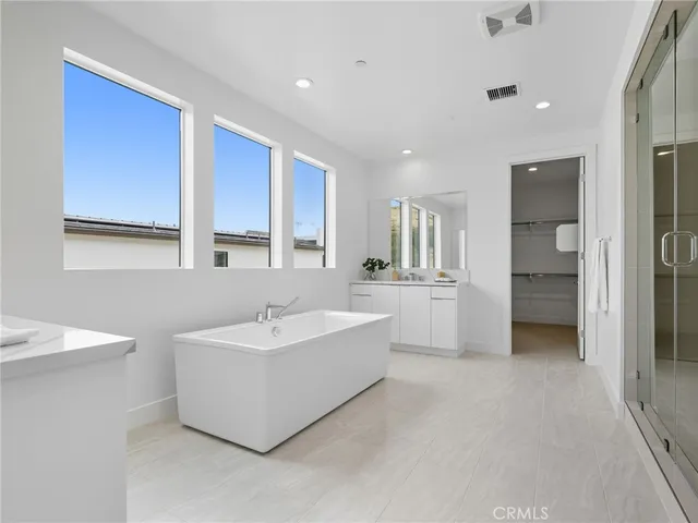 a bathroom with a sink tub shower and a mirror
