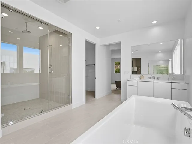 a bathroom with a bathtub and a shower