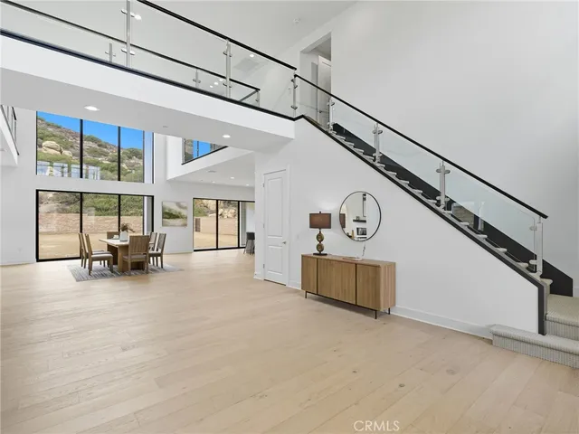 a view of a livingroom with furniture staircase and a ceiling fan