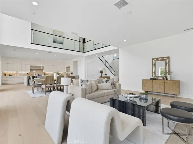 a living room with lots of furniture and a chandelier