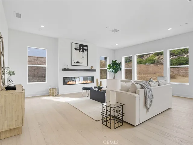 a living room with furniture and large windows