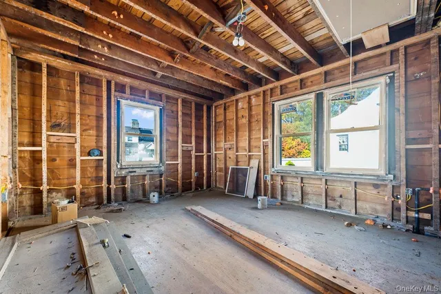 a view of living room with furniture and large windows