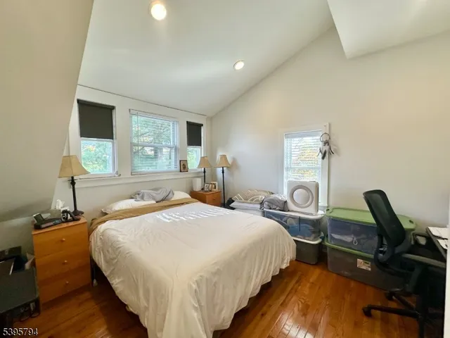 a bedroom with bed chair and window