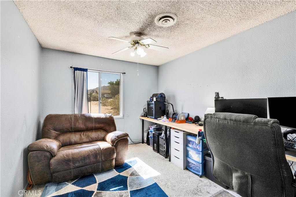 4805 Avenida La Mirada Joshua Tree, CA 92252 - Photo 18 of 38 a living room with furniture and a large window