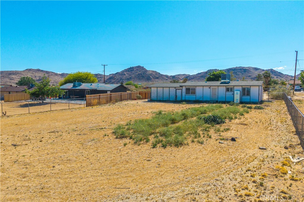 4805 Avenida La Mirada Joshua Tree, CA 92252 - Photo 30 of 38 a view of a house with a yard and mountain view