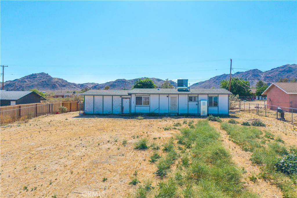 4805 Avenida La Mirada Joshua Tree, CA 92252 - Photo 31 of 38 a view of a house with a yard
