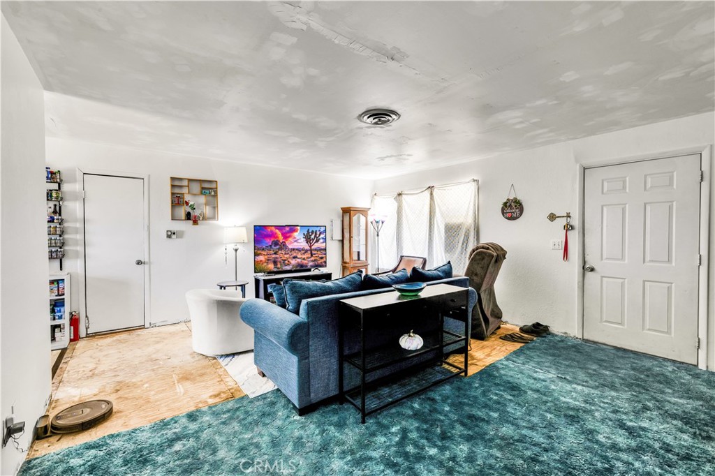 4805 Avenida La Mirada Joshua Tree, CA 92252 - Photo 5 of 38 a living room with furniture and a flat screen tv