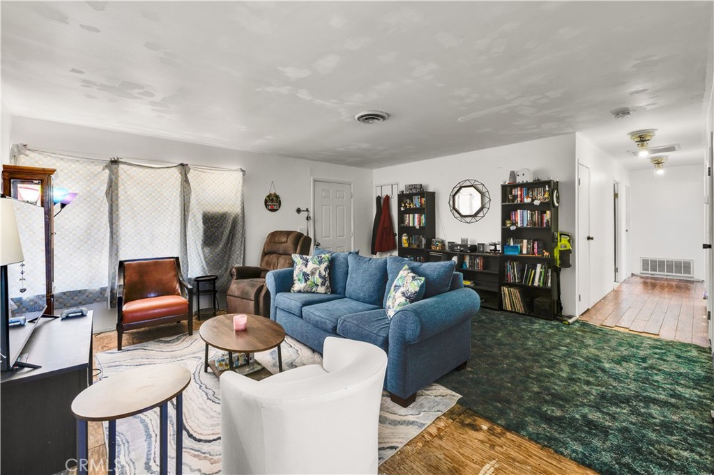 4805 Avenida La Mirada Joshua Tree, CA 92252 - Photo 6 of 38 a living room with furniture and a large window