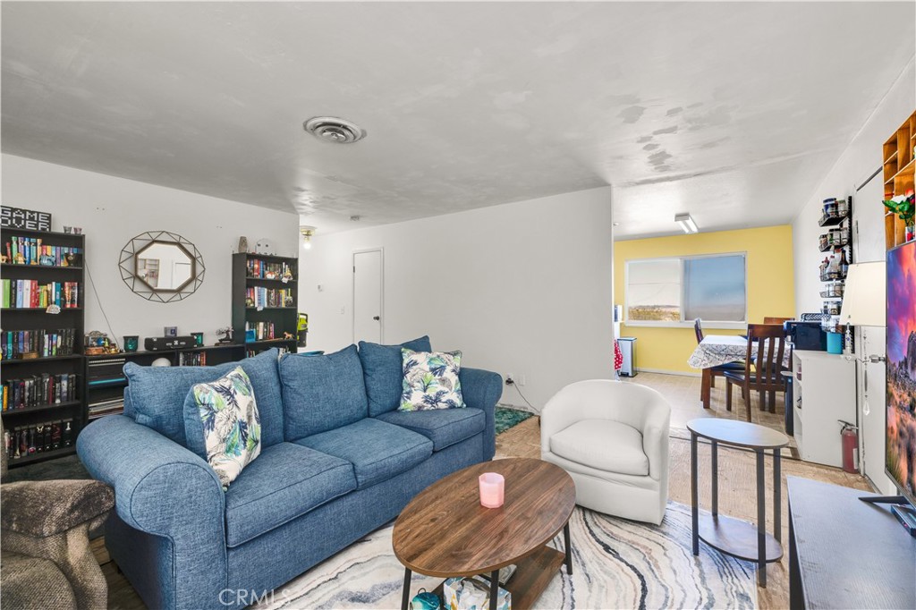 4805 Avenida La Mirada Joshua Tree, CA 92252 - Photo 7 of 38 a living room with furniture and a large window