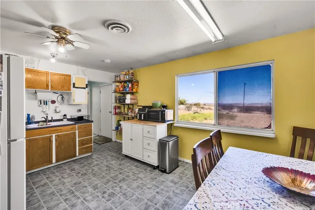 a view of a dining room with a table and chairs