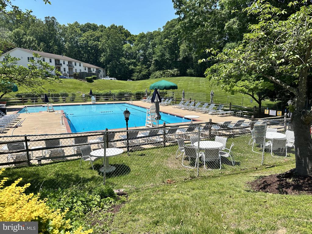 5900 Prince George Drive, Unit 333 Springfield, VA 22152 - Photo 26 of 31 a view of a swimming pool with a patio and a garden