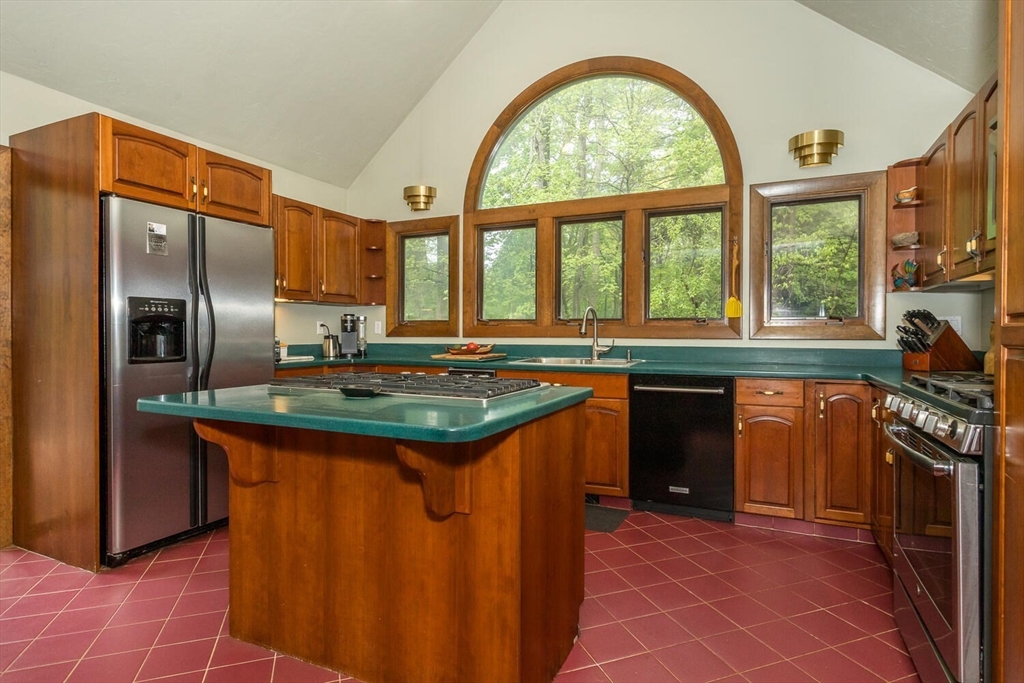 45 Strawberry Lane Canton, MA 02021 - Photo 13 of 32 a kitchen with stainless steel appliances granite countertop a stove a sink and a refrigerator