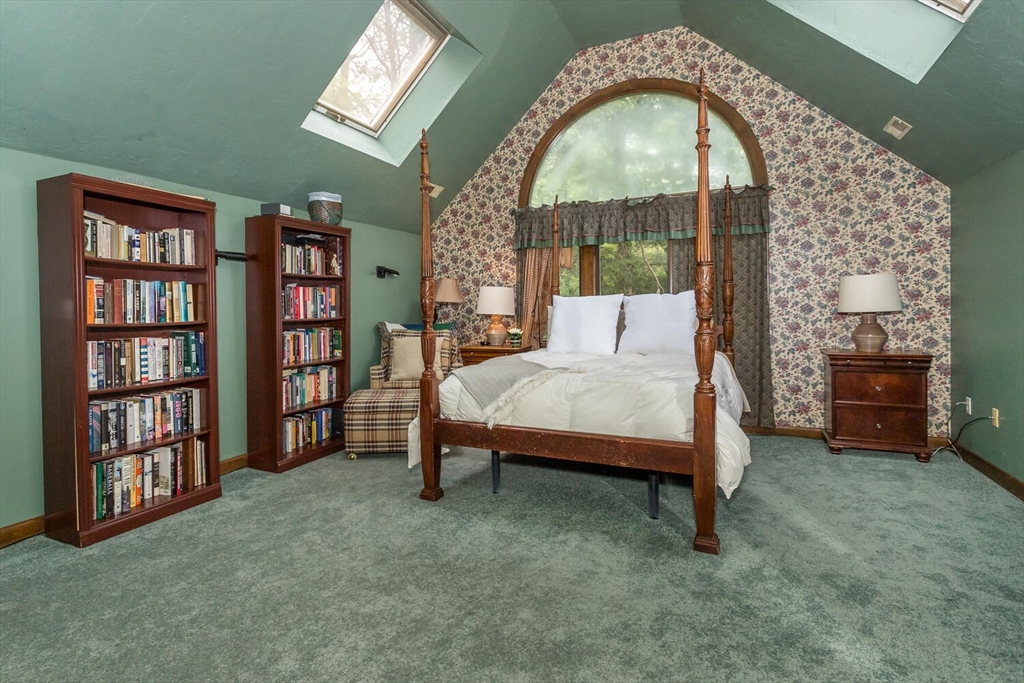 45 Strawberry Lane Canton, MA 02021 - Photo 18 of 32 a bedroom with a bed a bookshelf and a large window
