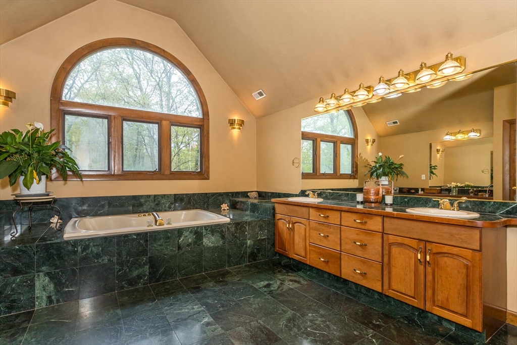 45 Strawberry Lane Canton, MA 02021 - Photo 20 of 32 a bathroom with a tub sink and mirror