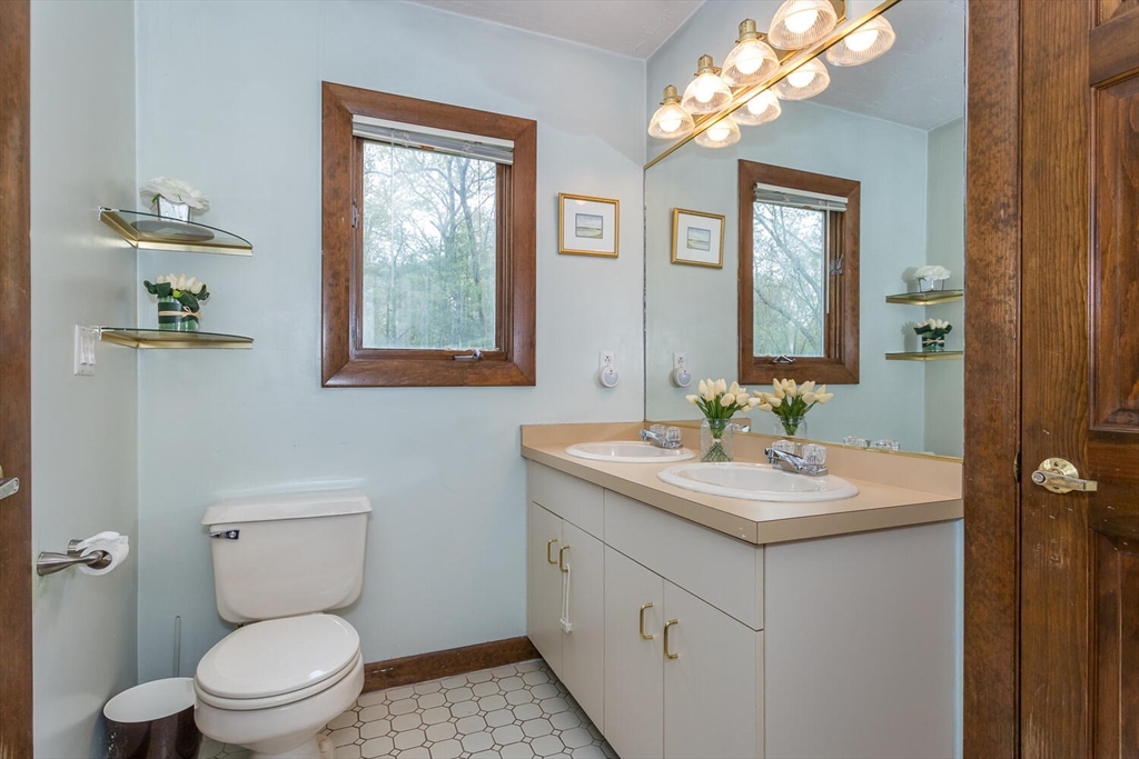 45 Strawberry Lane Canton, MA 02021 - Photo 25 of 32 a bathroom with a toilet a sink mirror and vanity