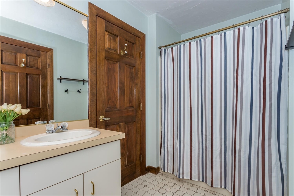 45 Strawberry Lane Canton, MA 02021 - Photo 26 of 32 a bathroom with a sink and a mirror