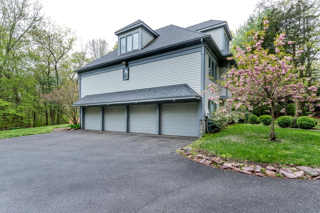 45 Strawberry Lane Canton, MA 02021 - Photo 3 of 32 a front view of a house with a yard and garage