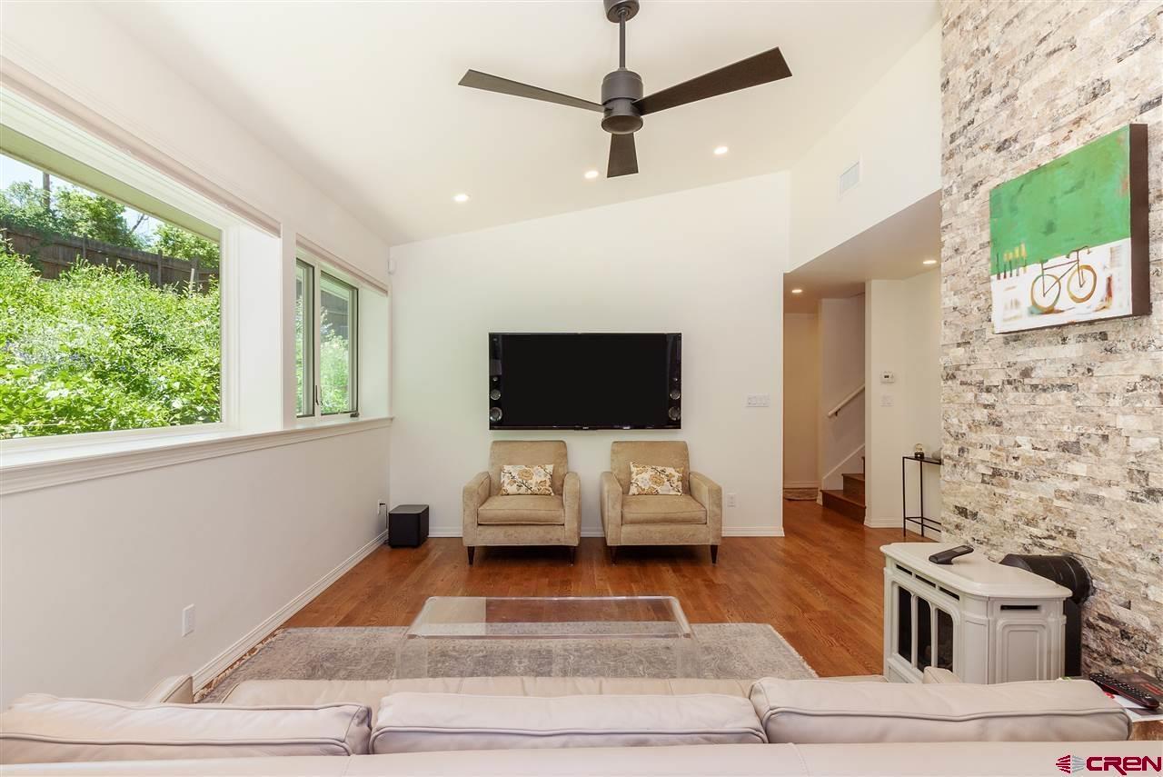 1404 East 3rd Avenue Durango, CO 81301 - Photo 11 of 24 a living room with furniture and a flat screen tv