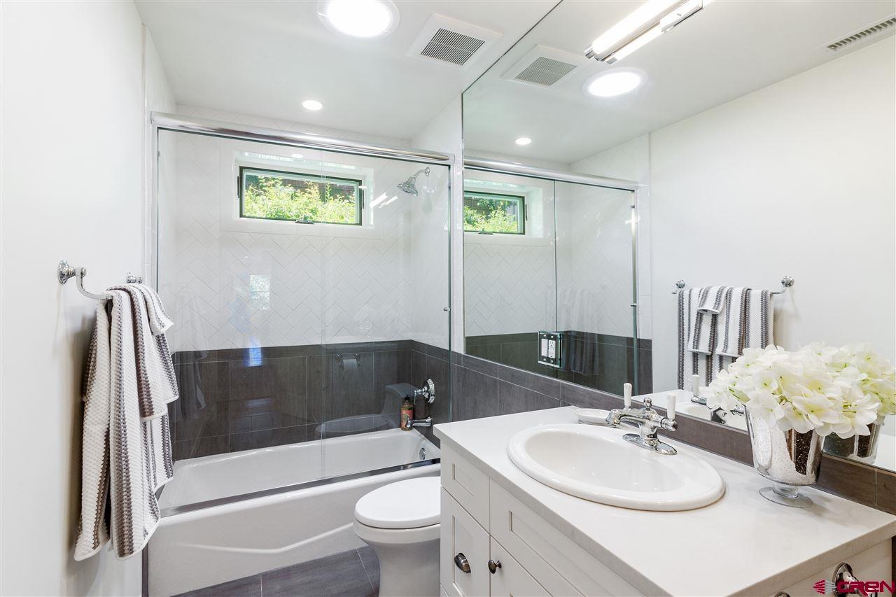 1404 East 3rd Avenue Durango, CO 81301 - Photo 12 of 24 a bathroom with a sink a toilet and shower