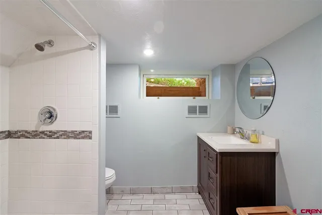 a bathroom with a sink a mirror and a toilet