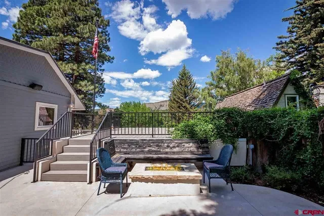 a backyard of a house with table and chairs