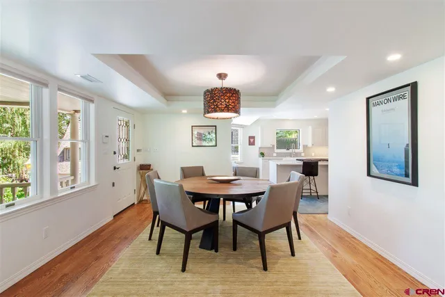 a view of a dining room with furniture window and wooden floor