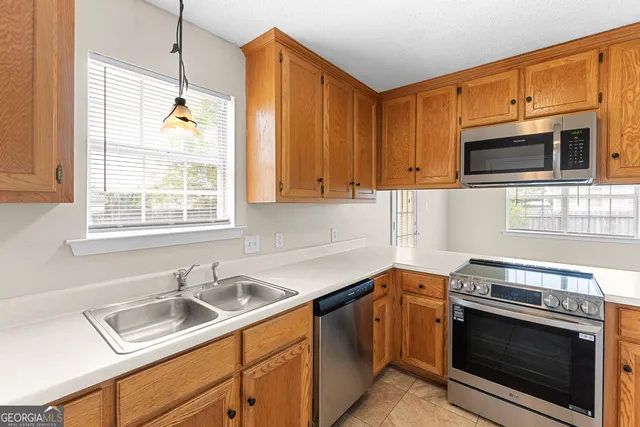 a kitchen with a sink cabinets and window