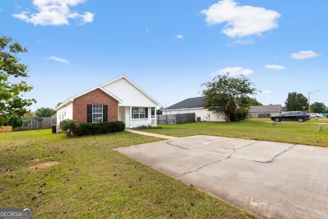 a view of house with yard outdoor seating and entertaining space