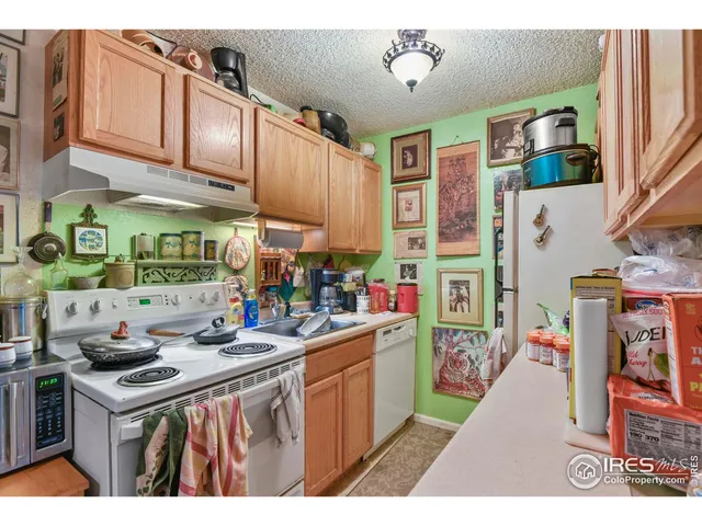 a kitchen that has a lot of cabinets a sink and a stove in it