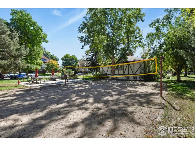 a view of street with houses and trees in the background