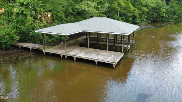 a view of house with swimming pool and yard