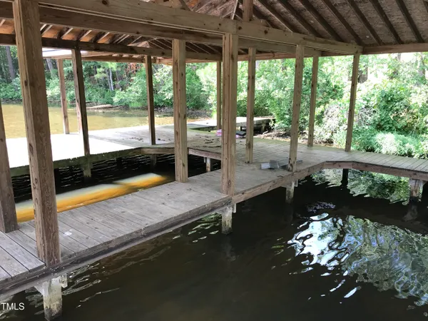 an aerial view of a house with swimming pool and large trees