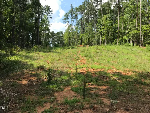 an aerial view of lake residential house with outdoor space and trees all around