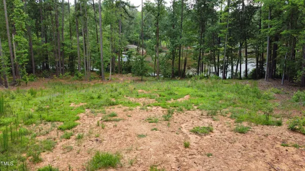 an aerial view of a house with swimming pool and outdoor seating