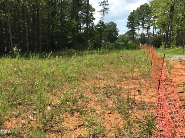 a backyard of a house with lots of green space and lake view